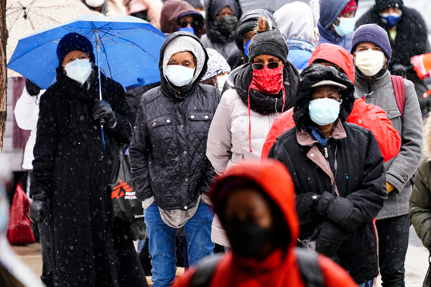 People wait in line at a 24-hour, walk-up COVID-19 vaccination clinic hosted by the Black Doctors COVID-19 Consortium at Temple University's Liacouras Center in Philadelphia, Friday, Feb. 19, 2021. (AP Photo/Matt Rourke)