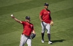 Twins third baseman Josh Donaldson played catch to loosen up next to Twins infielder Jorge Polanco at the start of the first full squad workout.