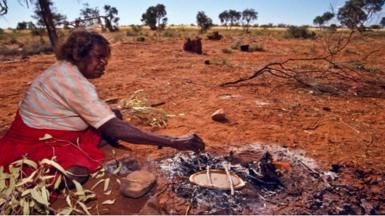 Woman baking in Australian outback