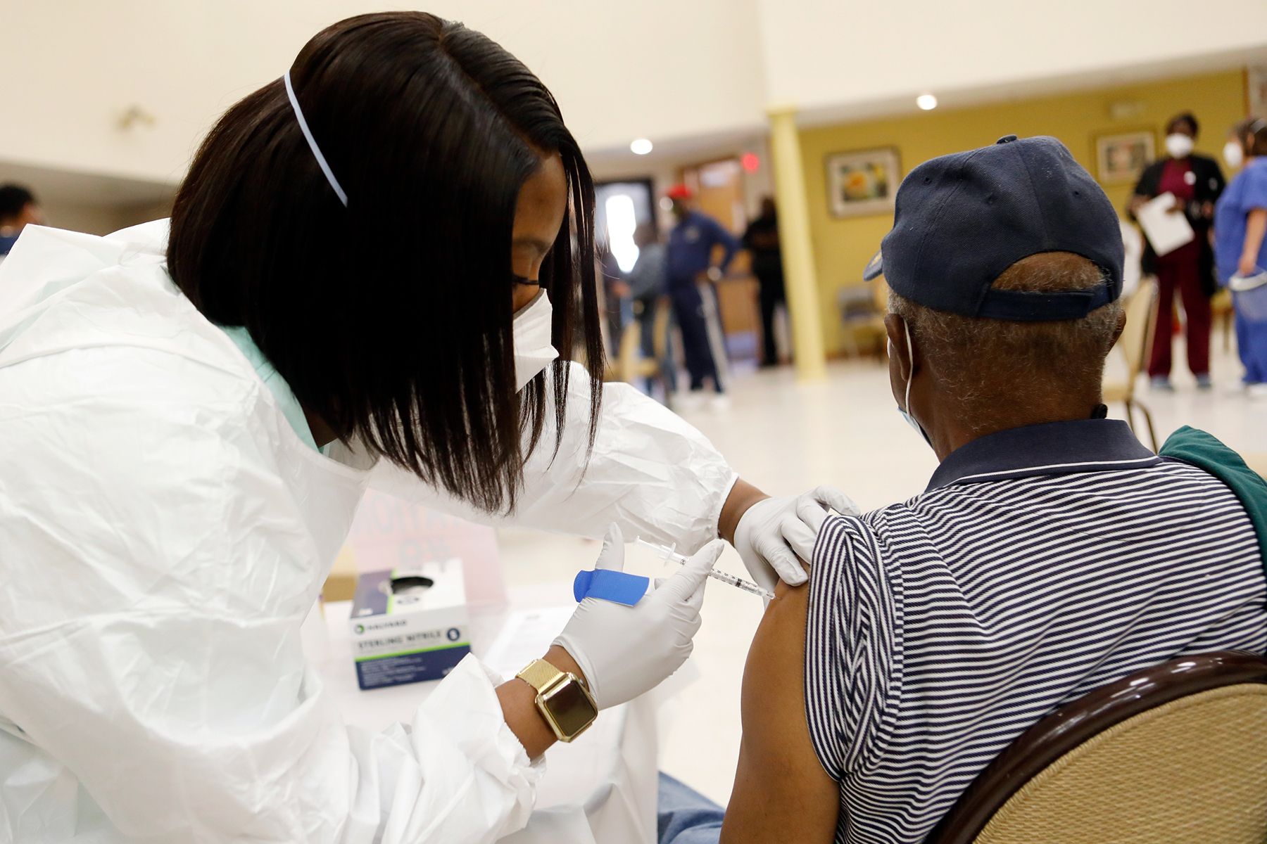 TAMPA, FL - JANUARY 10: Healthcare workers administer the COVID-19 vaccine to residents living in the Jackson Heights neighborhood at St. Johns Missionary Baptist Church on January 10, 2021 in Tampa, Florida. The Florida Department of Health is targeting the underserved populations that are most vulnerable to getting the coronavirus, specifically the African and Latin American communities. (Photo by Octavio Jones/Getty Images)