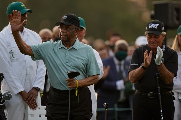 Lee Elder waves with Gary Player before the ceremonial first tee the first round of the Masters.