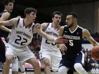 Gonzaga's Nigel Williams-Goss, right, drives the ball against Saint Mary's Dane Pineau (22) and Joe Rahon, center, during the first half of an NCAA co