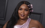 Lizzo poses in the press room at the 63rd annual Grammy Awards at the Los Angeles Convention Center on Sunday, March 14, 2021. 