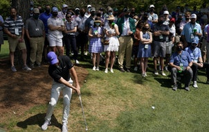 Rory McIlroy hits out of the rough on the sixth hole during the first round of the Masters