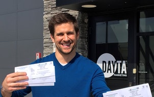 Luke Riordan, founder and chief executive officer of St. Cloud-based DAYTA Marketing, holds raffle tickets for a Big Brothers Big Sisters fundraiser.