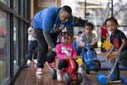 Tynise Underwood pushed preschooler Kamiyah Henry on a scooter at a New Horizon Academy childcare center in north Minneapolis in March.