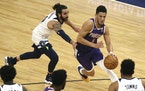 Devin Booker (1) drives the ball past Ricky Rubio (9) in the first half.