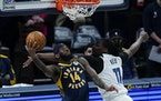 Indiana’s JaKarr Sampson goes up for a dunk against the Timberwolves’ Naz Reid during the first half