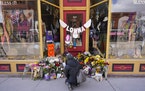 Flowers lie outside the store owned by one of the 10 victims in the mass shooting in Boulder, Colo.