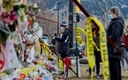 Mourners pay respects at a makeshift memorial for the victims of a shooting in Boulder, Colo.