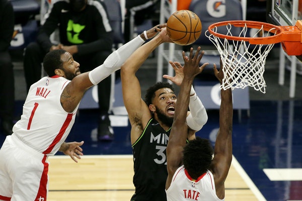 Minnesota Timberwolves center Karl-Anthony Towns (32) shoots against Houston Rockets guard John Wall (1) and forward Jae&#39;Sean Tate (8) in the firs