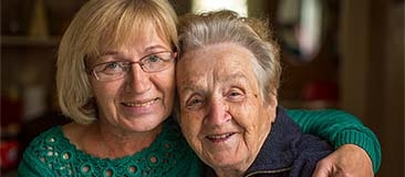 Older woman caring for her mother who has Alzheimer's disease