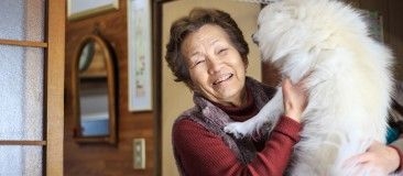 older woman holding dog