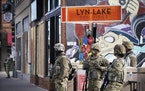 Minnesota National Guard members patrol Lyndale Avenue S. near Lake Street. Twin Cities residents are holding their breaths as they await a verdict in