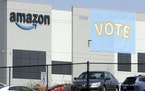 A banner encouraging workers to vote in labor balloting is shown at an Amazon warehouse in Bessemer, Ala., on Tuesday, March 30, 2021.