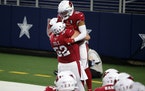 Mason Cole (52) celebrated a touchdown with Christian Kirk (13) for Arizona in October. 