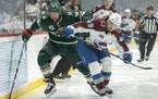 Jordan Greenway of the Minnesota Wild and Samuel Girard of the Colorado Avalanche chased the puck in the first period.