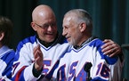 In this Feb. 21, 2015, photo, Jack O’Callahan, left, and Mark Pavelich of the 1980 U.S. ice hockey team talk during a “Relive the Miracle” reuni