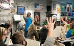 At a socially distanced painting class, Tara Tepley, the owner of the Paint Factory in Hutchinson, Minn., asked who had attended one of her classes be
