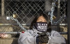 Kaia Hirt, a Twin Cities teacher, waschained to a fence outside the Hennepin County Government Center, Tuesday, March 30, 2021 in Minneapolis.