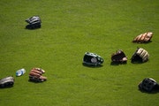 Twins outfielders’ gloves sat on the grass during spring training in Fort Myers, Fla.