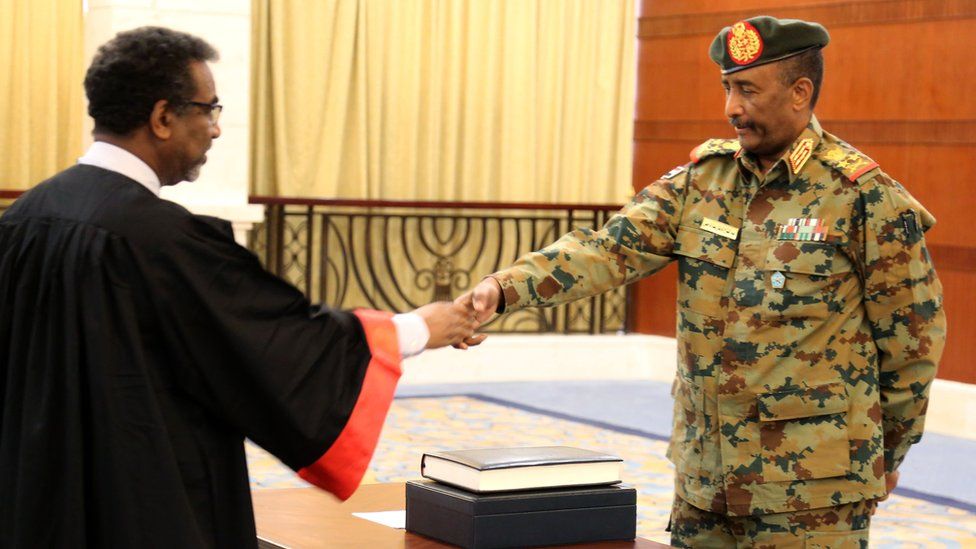 A picture released by Sudan"s Presidential Palace shows General Abdel Fattah al-Burhan, the head of Sudan"s ruling military council, during a swearing in ceremony i