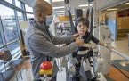 Tony Lee was by Navon’s side as he took on the Lokomat machine during a physical therapy visit at Gillette Children’s Specialty Healthcare on Feb.