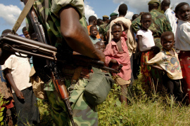 Young villagers watch a Democratic Republic of the Congo commando on October 8, 2005, in Aba, Northern Ituri [File: Lionel Healing/AFP]