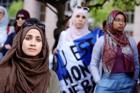 Women protest against Quebec's Bill 21, which bans teachers, police, government lawyers and others in positions of authority from wearing religious symbols on the job [File: Christinne Muschi/Reuters]