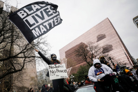 Alex Harder waves a Black Lives Matter flag during a march through downtown after the closing statements in the trial of former police officer Derek Chauvin, who is facing murder charges in the death of George Floyd, in Minneapolis, Minnesota, the United States, on April 19, 2021 [Nicholas Pfosi/Reuters]