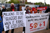 Supporters hold up banners as they protest against Manchester United&#39;s owners, outside the Premier League club&#39;s Old Trafford stadium [File: Oli Scarff/AFP]