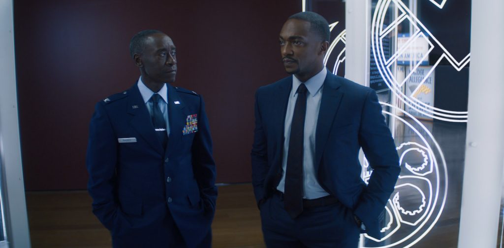(L-R): Rhodey (Don Cheadle) and Falcon/Sam Wilson (Anthony Mackie) in Marvel Studios' THE FALCON AND THE WINTER SOLDIER exclusively on Disney+. Photo courtesy of Marvel Studios. ©Marvel Studios 2021. All Rights Reserved.