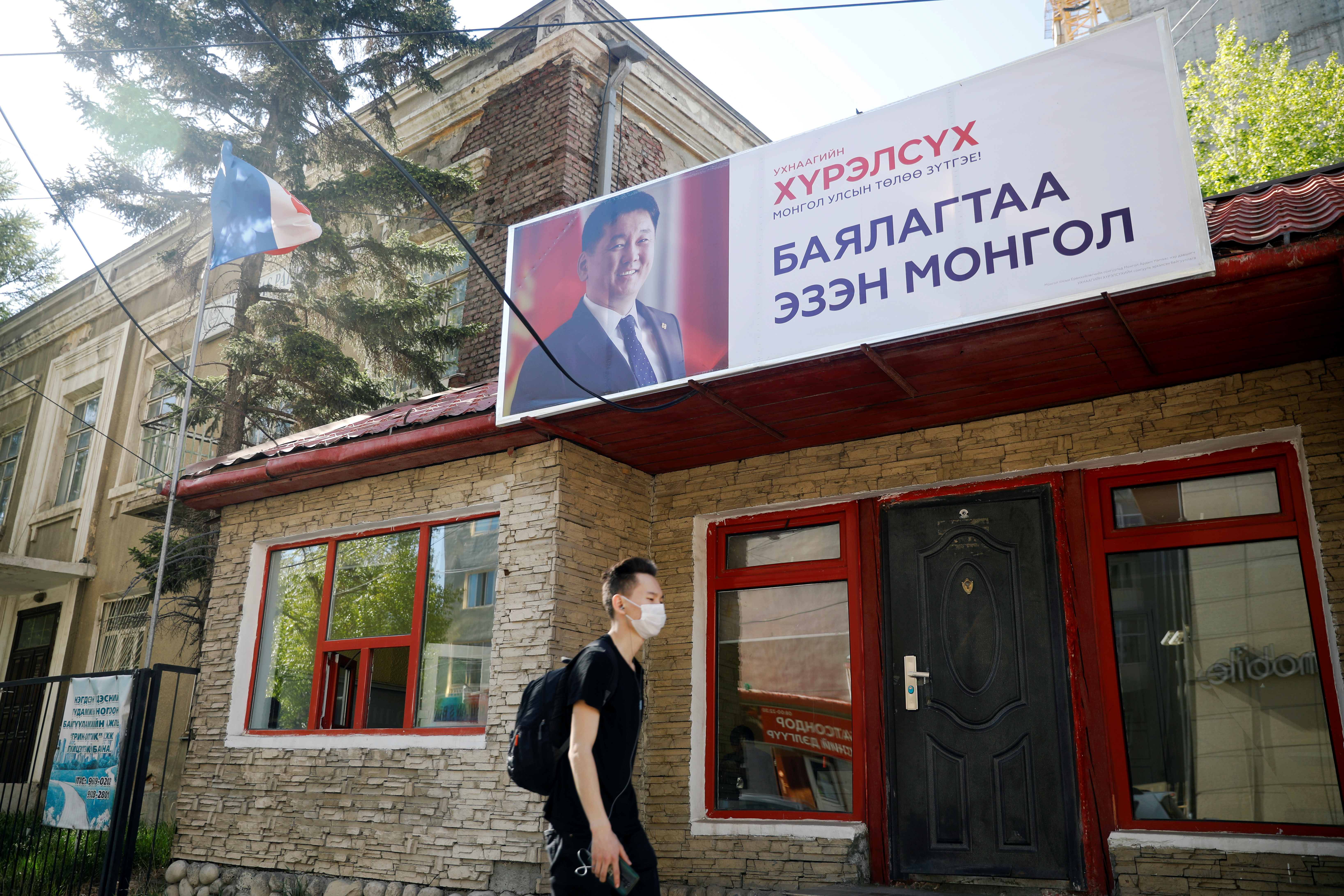 A man walks past a campaign office for Ukhnaa Khurelsukh, presidential candidate of the Mongolian People's Party, ahead of the presidential election, in Ulaanbaatar, Mongolia June 3, 2021.   REUTERS/B. Rentsendorj