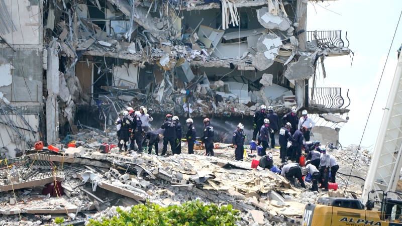 Rescue workers search the rubble of the Champlain Towers South condominium, Saturday, June 26, 2021, in the Surfside area of Miami. The building partially collapsed on Thursday. (AP Photo/Lynne Sladky) 