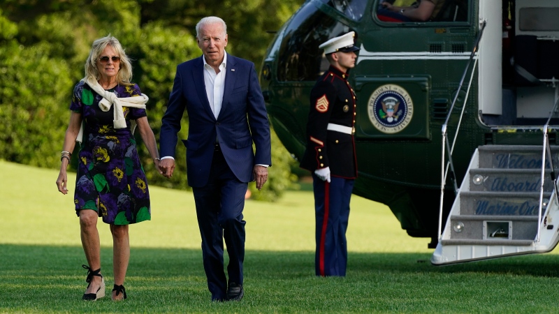 U.S. President Joe Biden and first lady Jill Biden walk on the South Lawn of the White House after stepping off Marine One, Sunday, June 27, 2021, in Washington. (AP Photo/Patrick Semansky)