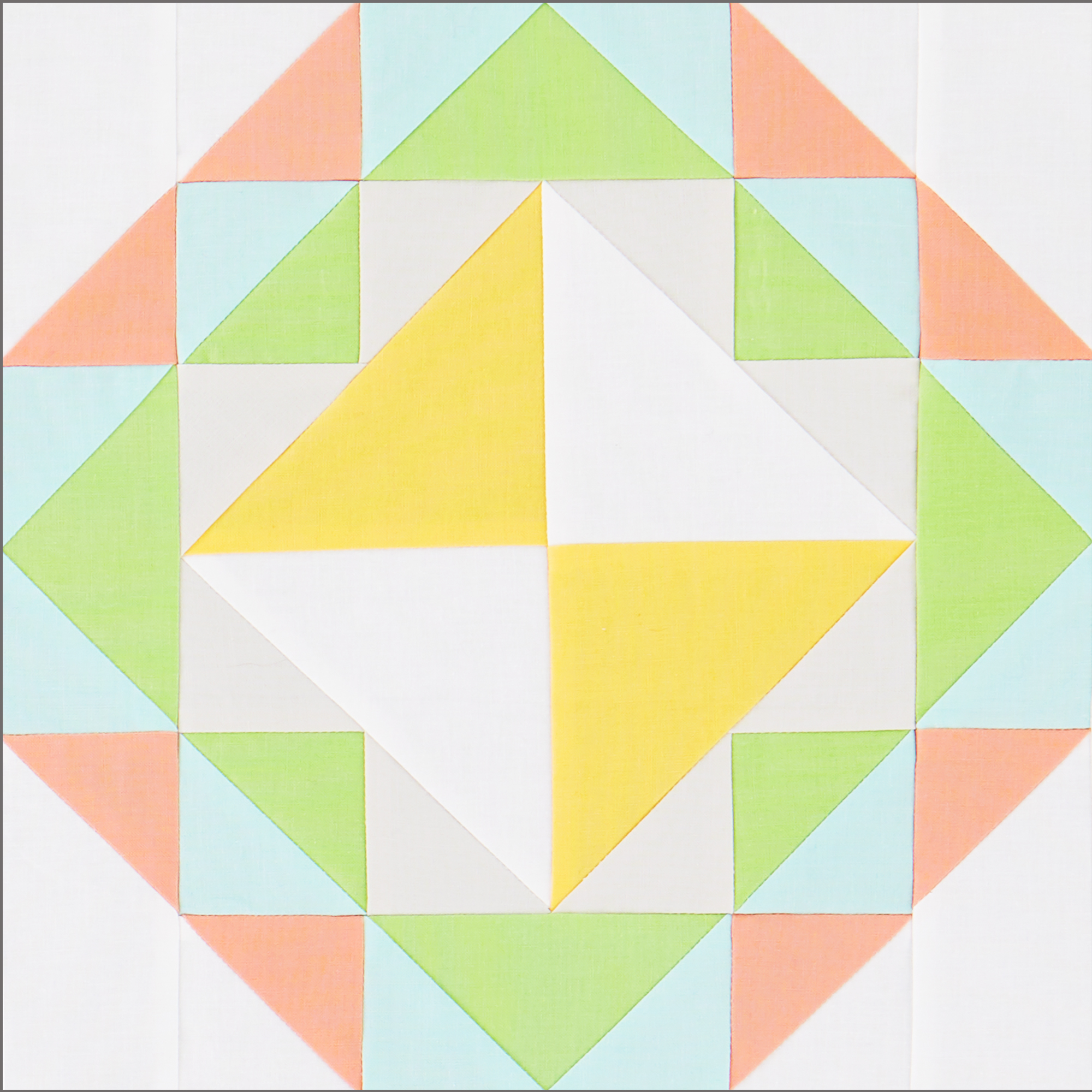 Block with Hourglass, Flying Geese and Triangle Squares in Pink, Blue, Green, and Yellow Solids.