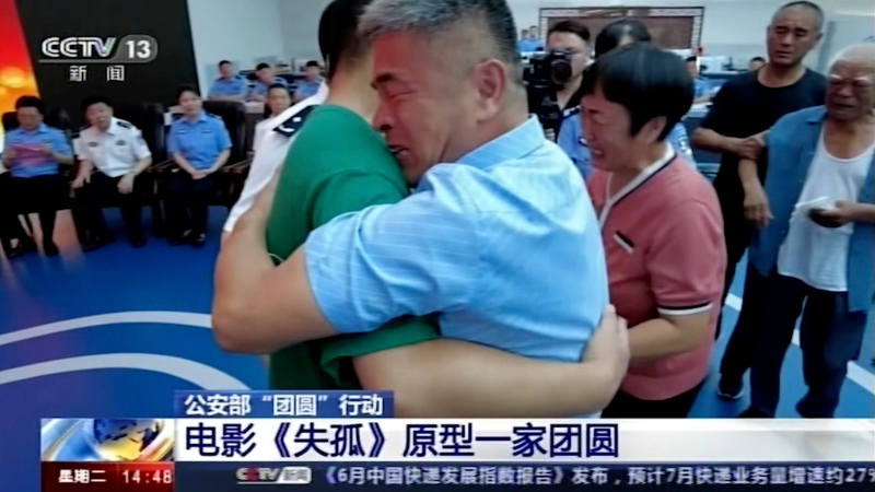 In this image taken from a video footage run by China's CCTV via AP Video, Guo Gangtang at right embraces his long lost son Guo Xinzhen during a reunion after 24 years in Liaocheng in Central China's Shandong province on Sunday, July 11, 2021. Guo was abducted as a toddler outside their home. (CCTV via AP Video)