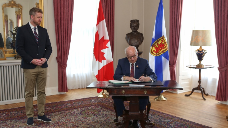 Premier Iain Rankin and Lt.-Gov. Arthur J. LeBlanc as he signs the proclamation to dissolve the legislature and call a general election (Photo courtesy: Communications Nova Scotia)