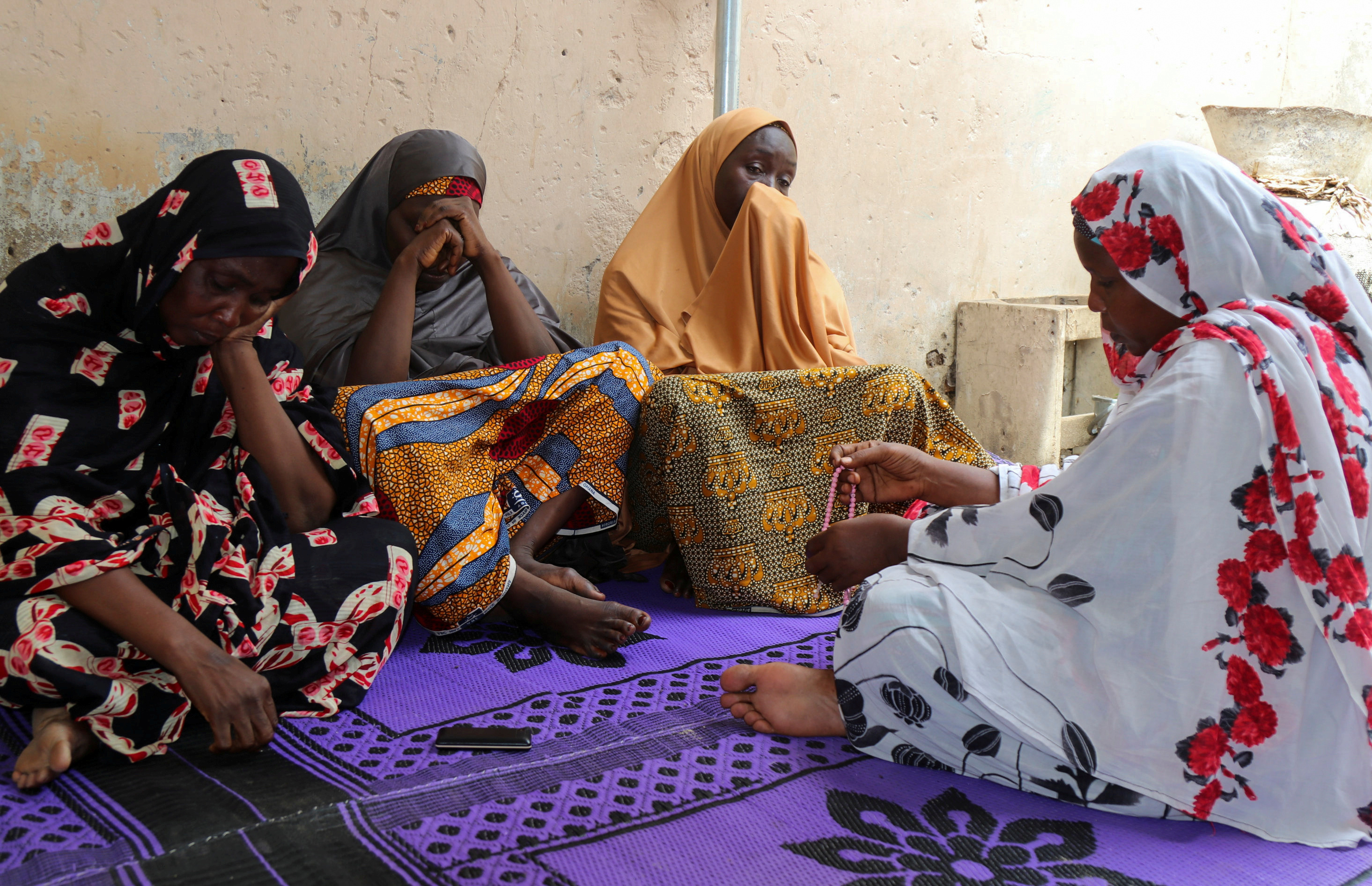 Women mourn the death of one of the aid workers who were executed by Islamist militants, in the northeast Nigerian city of Maiduguri, Nigeria July 23, 2020. REUTERS/Kolawole Adewale    
