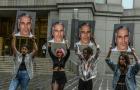 Protest group called "Hot Mess" hold up photos of Jeffrey Epstein in front of the Federal courthouse in New York City