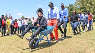 William Ruto pushing a wheelbarrow