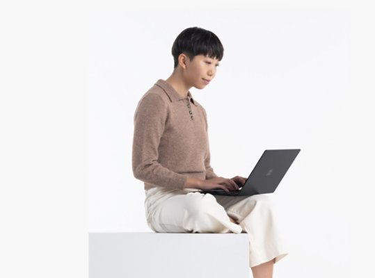 A person uses Surface Laptop 4 in Matte Black.
