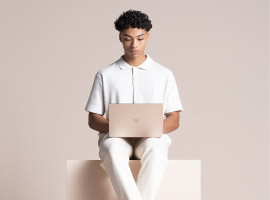 A person uses Surface Laptop 4 in Sandstone.