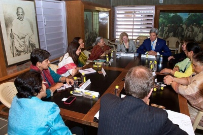 Secretary of State John Kerry sits with U.S. Ambassador-at-Large for Global Women's Issues Cathy Russell and a group of Indian women to talk about economic and social empowerment during a visit to the Sabarmati Ashram. The Sabarmati Ashram is where Mahatma Gandhi lived and launched his famed Salt March. 