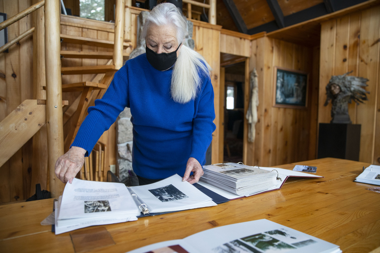 At her cabin, Leddy looked through photos books stuffed with images of their deep Gunflint Trail history.