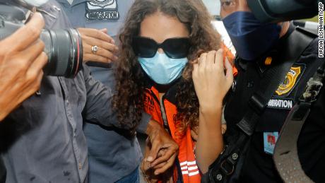 Heather Mack of Chicago, Ill., center, escorted by Indonesian immigration officers to Immigration detention center in Jimbaran, Bali, Indonesia on Friday, Oct. 29, 2021. The American woman convicted of helping to kill her mother on Indonesia&#39;s tourist island of Bali in 2014 walked free from prison Friday after serving seven years of a 10-year sentence and will be deported to the United States. (AP Photo/Firdia Lisnawati)