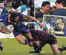 Otago halfback Byron Kelleher is clipped by Canterbury fullback Leon MacDonald during the 2001...