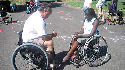 YES student Stella Tiyoy from Kenya meets with a physical therapist and wheelchair user to discuss opportunities to participate in wheelchair sports in the United States.