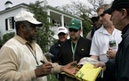 Lee Elder signs autographs for patrons outside the club house at the 2008 Masters golf tournament at the Augusta National Golf Club. Elder has died at