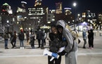 Nyagach Kueth, 17, and Markeanna Dionne, 17, hugged Friday as they led a rally outside U.S. Bank Stadium in support of the Prior Lake High School stud